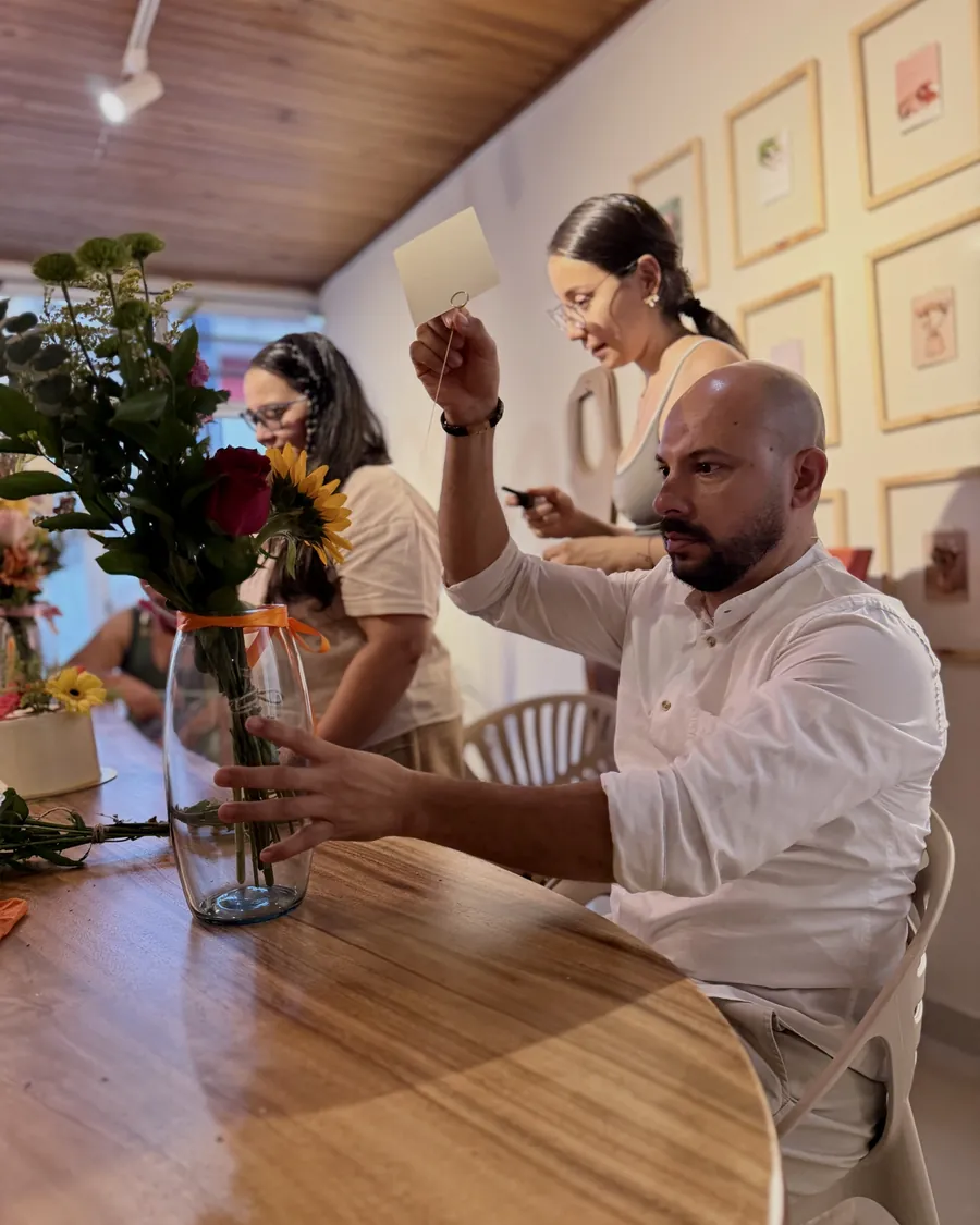 Two at a time — One sunflower, one vase and four hands deciding where each stem goes.
