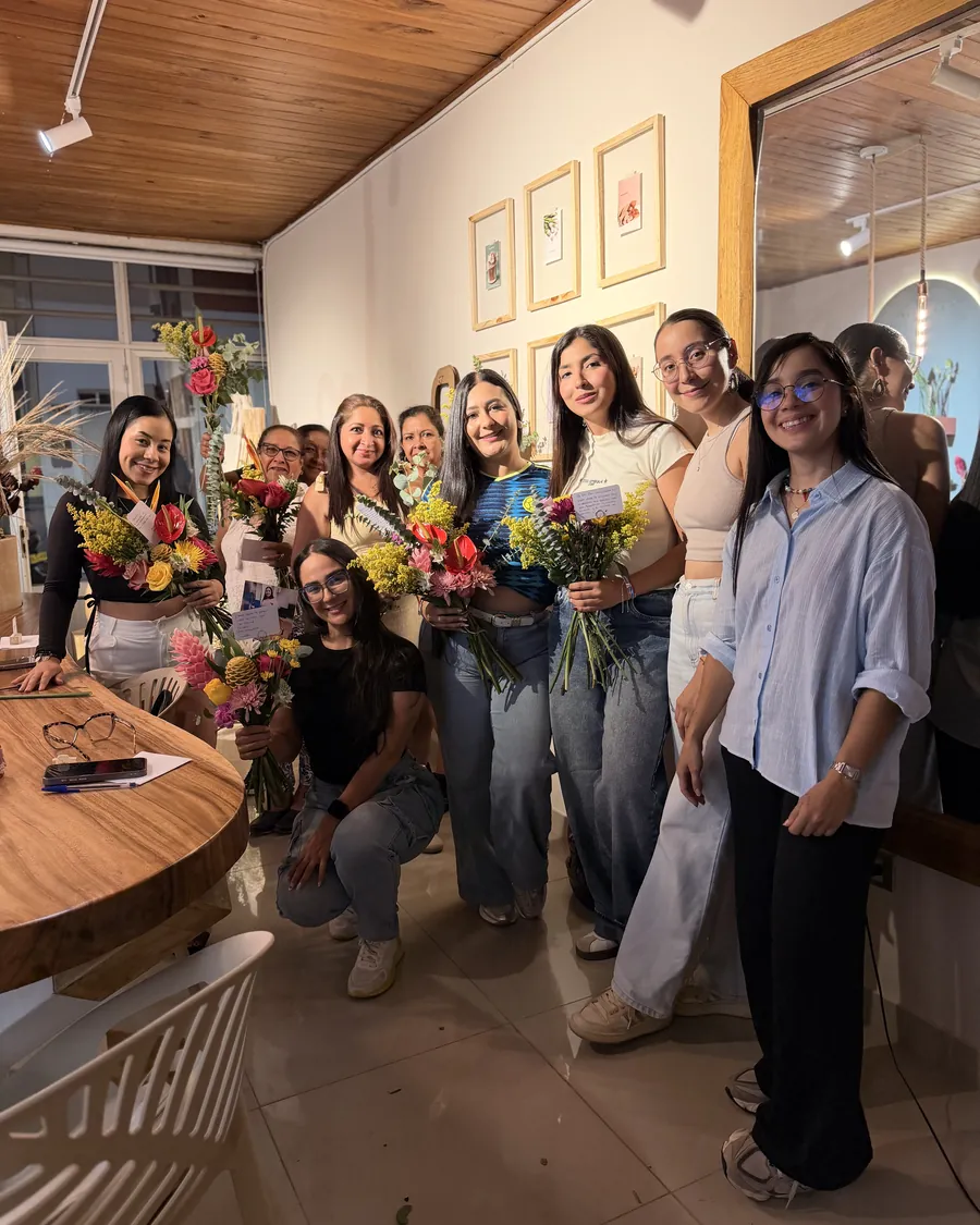 The closing photo — Everyone holding their finished bouquet, the way the afternoon usually ends.