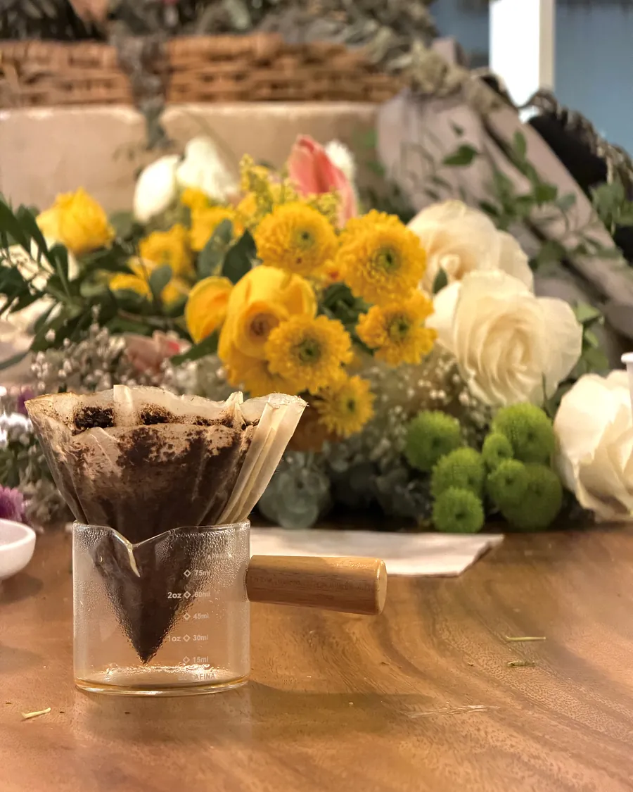 Sunflowers and coffee — The filter set and the flowers of the day waiting on the wood.