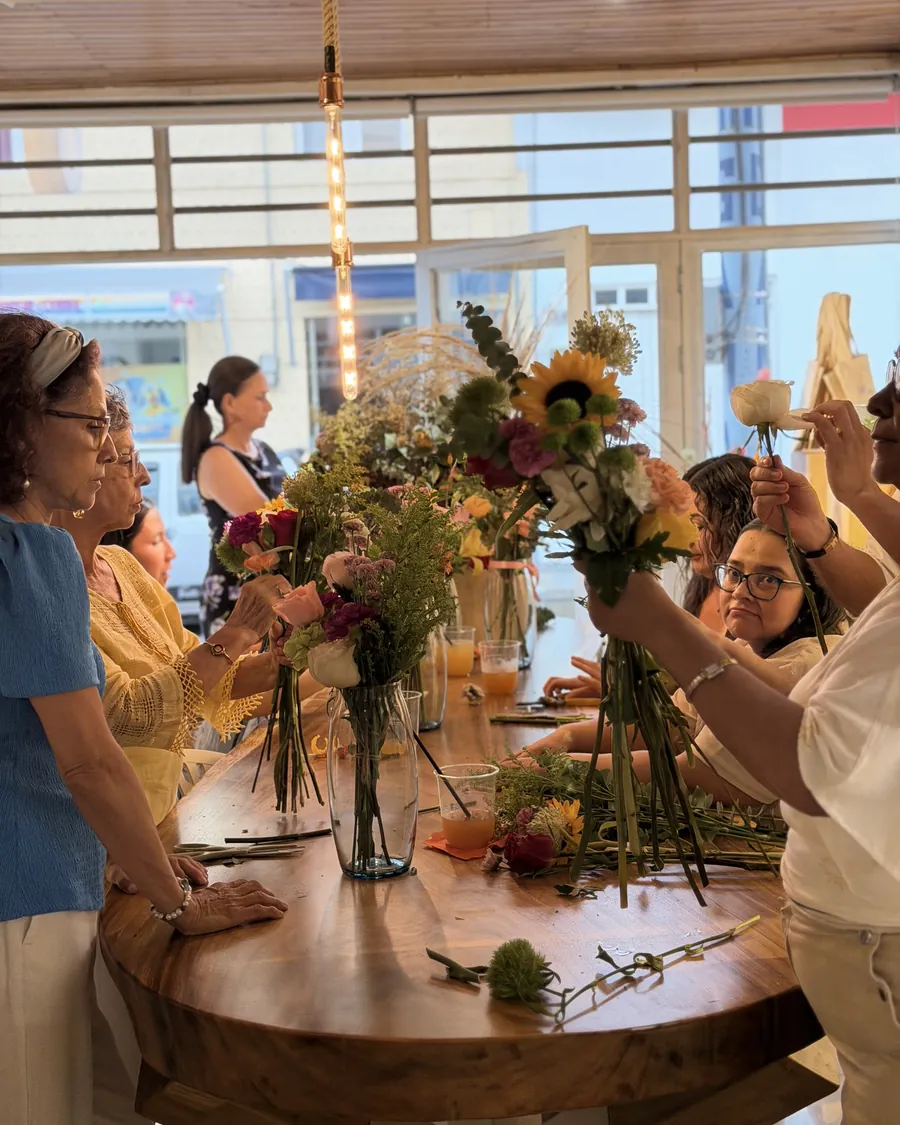 Hands on — Everyone picks their own stems and builds their own bouquet. We just guide.